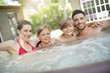 Family of 4 enjoying bath in spa