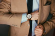 Businessman luxury style. Men style.correct button on jacket, hands close-up, dressing, man's style, stylish man.Fashion portrait of young businessman handsome model man in casual cloth suit.