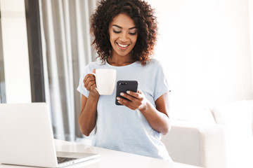 Sticker - Smiling african woman using mobile phone