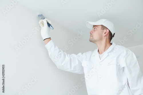 Painting Painter With Paint Brush Covering Ceiling Angle With