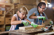 © pikselstock - Two young girls doing woodwork in a workshop