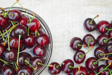 Wall Mural - Spelled cherries on the white wooden background