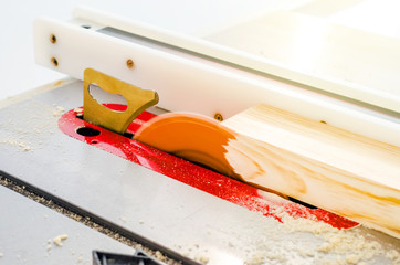 Poster - Cutting the board on a circular saw in a woodworking workshop