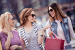 © ivanko80 - Cheerful girls with shopping bags in the city