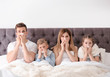 © New Africa - Family suffering from cold in bed at home