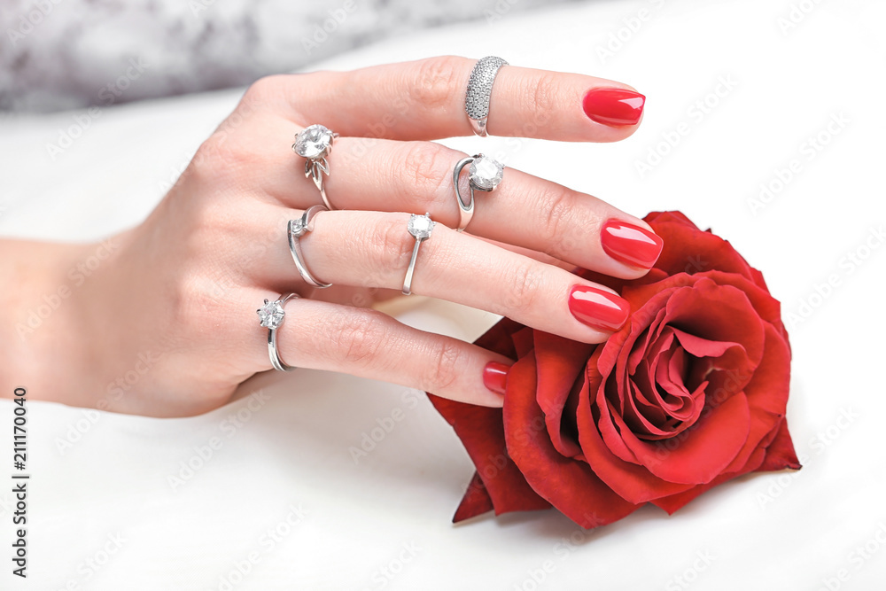 Woman wearing many different engagement rings, closeup