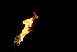 Fototapeta  - flame of a torch in the dark on a black background, only the fire is visible