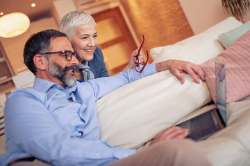 Wall Mural - Mature couple using laptop