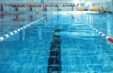 Modern swimming pool with blue water, indoors