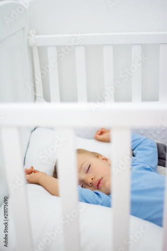 Baby Boy Sleeping In His White Wooden Crib Toddles Napping In His
