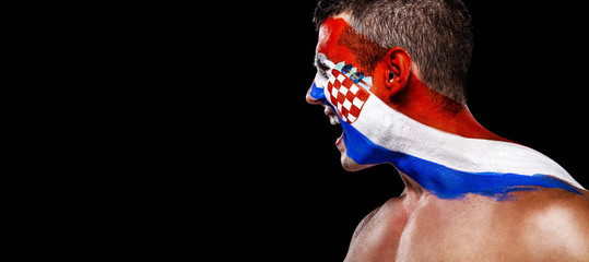 Soccer or football fan with bodyart on face with agression - flag of Croatia.