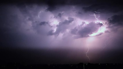 night stormy sky above city. set of beautiful lightning strikes. thunderstorm clouds. timelapse. slo