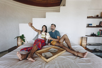 Wall Mural - Couple relaxing on the bed