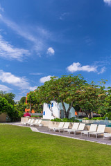 Sunbathing lounger swimming pool side./ Sunbathing lounger swimming pool side and flower pot on summer.
