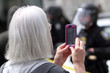 © Peter Kim - Protestor filming police with her cellphone.