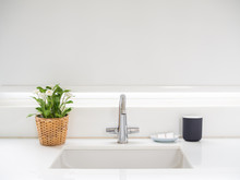 Clean White Bathroom Interior With Sink Basin Faucet, Flower In Weave Pot, Soap And Ceramic Mug. Modern Design Of Bathroom With Copy Space.