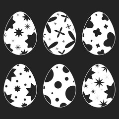 Wall Mural - Set of white isolated silhouettes of Easter eggs on a black background. With an abstract pattern. Simple flat vector illustration. Suitable for decoration of postcards