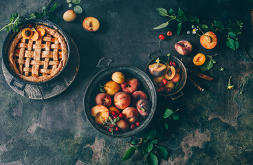 Wall Mural - Fruit pie on colorful wooden rustic background with fresh peaches