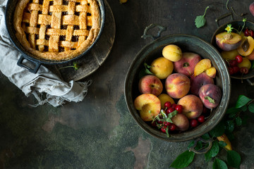 Wall Mural - Fruit pie on colorful wooden rustic background with fresh peaches