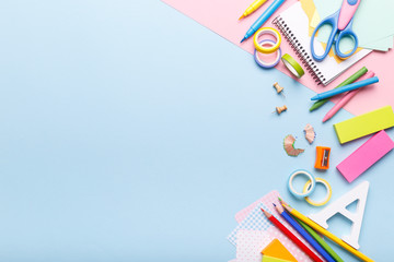 Colorful stationary school supplies on blue trending background, space or text flat lay