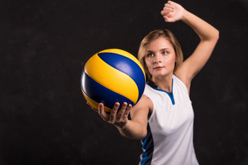 Wall Mural - Girl playing volleyball on a dark background