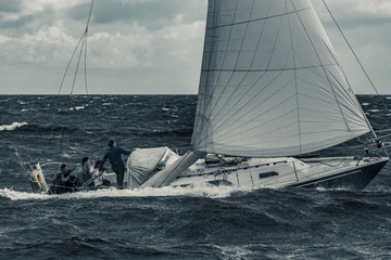 Canvas Print - Blue sailboat at storm