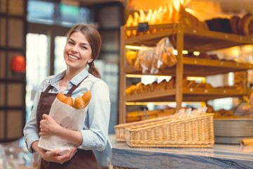 Young baker with baguettes