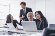 © Pormezz - Marketing team consulting sales plan with supervisor senior manager in conference room before presenting to client.