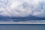 Fototapeta Morze - dense rain clouds over the sea