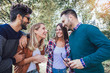© Mediteraneo - Group of young people walking through park. Friends having fun outdoor