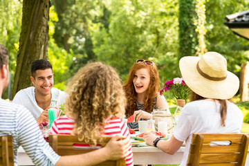 Wall Mural - Smiling red-haired woman have fun during garden party with multicultural friends