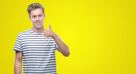 Sticker - Young handsome blond man wearing stripes sailor t-shirt happy with big smile doing ok sign, thumb up with fingers, excellent sign