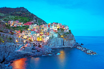 Wall Mural - magical beautiful landscape with bright colored houses on the rock on the sea coast of manarola in c