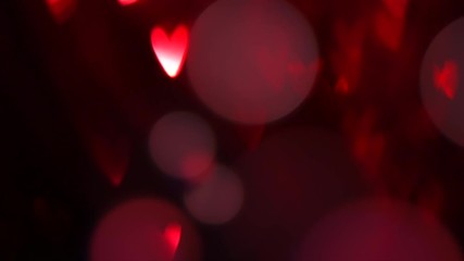 Wall Mural - Valentine's Day background. Holiday abstract background with red glowing hearts. Slow motion 4K UHD video footage. 3840X2160