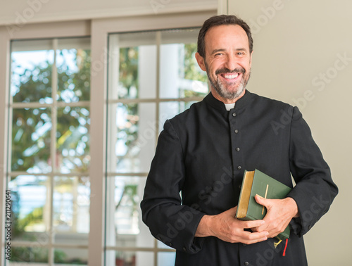 Fotomural Christian priest man with a happy face standing and smiling with a confident smi