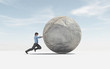Man pushing a big sphere to the top. Success concept.