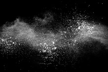 Bizarre Forms Of  White Powder Explosion Cloud Against Dark Background. Launched White Particle Splash On Black Background