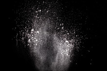 Bizarre Forms Of  White Powder Explosion Cloud Against Dark Background. Launched White Particle Splash On Black Background