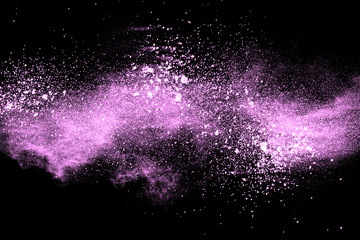 Wall Mural - Abstract pink powder explosion on  black background. Freeze motion of pink dust splashing.