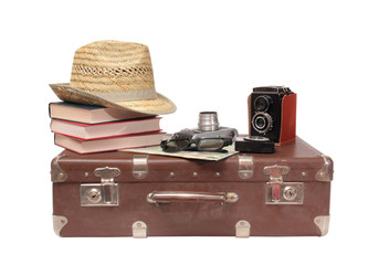 Vintage suitcase and old camera on a white background