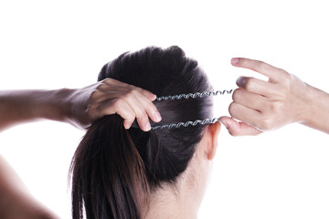 Wall Mural - Asian woman tying her hair