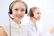 © rogerphoto - Bright  call center office. Two blonde women in a headset