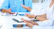 © rogerphoto - Group of doctors applauding at medical meeting. Close up of physician hands. Teamwork in medicine