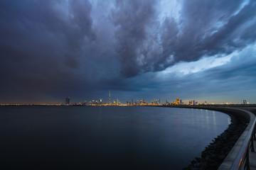 Skyline of Dubai with dark cloudy sky 