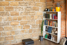 The Background Texture Is Sandstone. Sandstone Wall. Brick Sandstone. Shell Rock Brick Wall. Potted Flowers On The Floor. Bookshelf With Little Things. Interior Conaty. Guitar On The Shelf