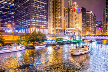 Wall Mural - Beautiful downtown Chicago at night with lit buildings, river and bridge.