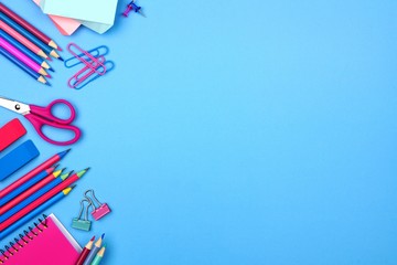 School supplies side border against a pastel blue paper background. Pink and blue color theme.