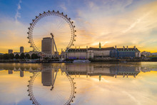 The London Eye With Water Reflection At Sunrise  In London. England
