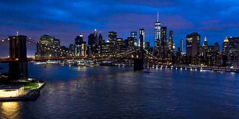 Wall Mural - JUNE 2, 2018 - NEW YORK, NEW YORK, USA  - New York City and East River shows Brooklyn Bridge and Manhatten Skyline  as seen from Queens