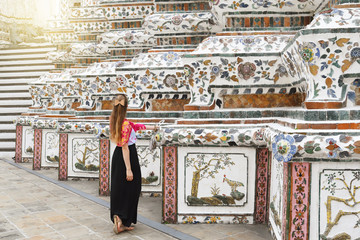 Wall Mural - Woman tourist is enjoy sightseeing inside Wat Arun temple in Bangkok, Thailand.
